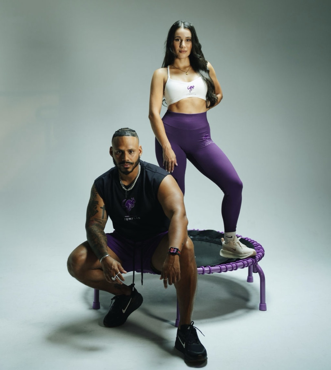 Two JumpLab athletes with a purple trampoline